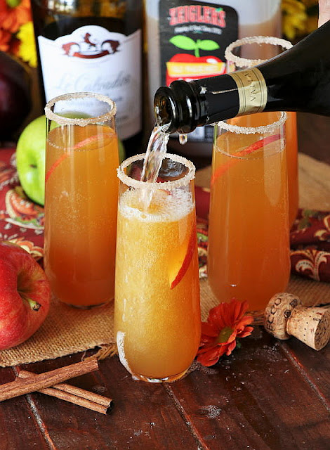 Pouring Sparkling Wine into Apple Cider Mimosas Image