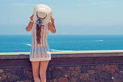 summer hat worn by a girl near a beach