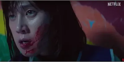 A female contestant with blood on her face shows fear and desperation in a dramatic scene from Season 3.