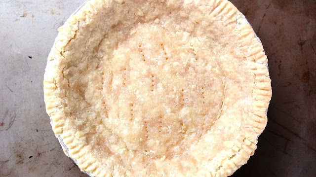 a pre-baked sourdough pie crust sitting on a rustic baking sheet