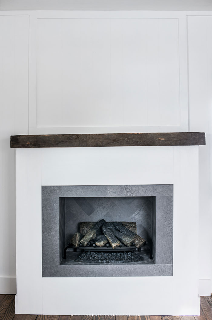 White fireplace with logs