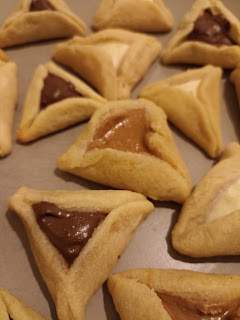 hamantaschen, which are triangle cookies filled with various sweet fillings