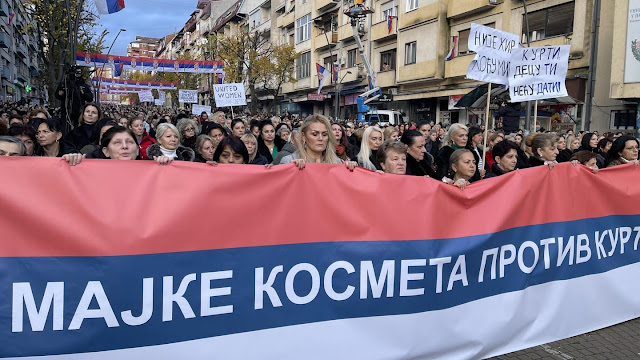 Serbian women protesting in North Kosovo while holding a large banner that reads "Mothers of Kosovo against the Kurti ghetto"