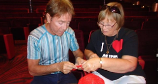 Cliff Richard learns to knit a poppy.