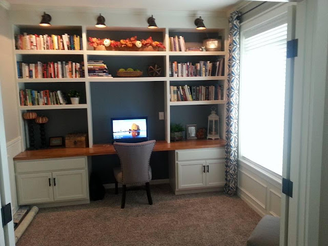 wall of bookcases with desk