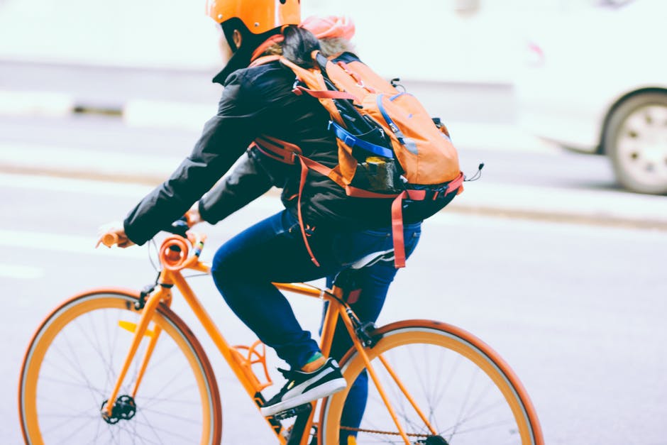 Man In Jacket Riding Bicycle