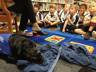 Shot of Coach with his bone and the children looking up at Kathleen.