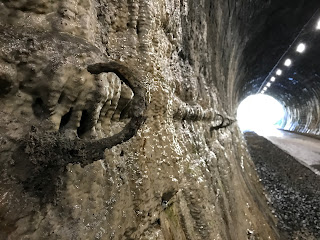 A photo of a rusting hook on the tunnel wall which is dissolving over the hook.  Photograph by Kevin Nosferatu for the Skulferatu Project.