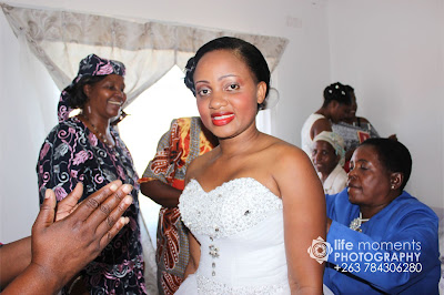 Nomsa Nyauchi Wearing a white gown.