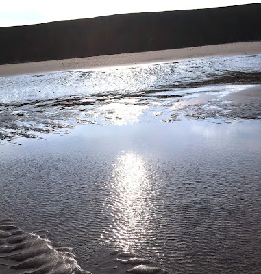 Sunbeams reflected in the sand at Tunstall East Yorkshire