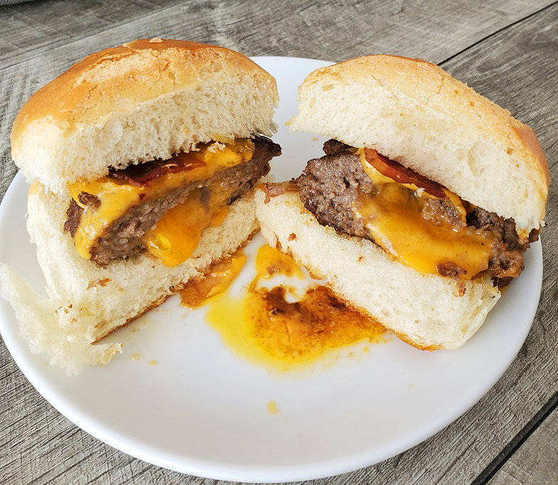 this is a cheeseburger cut in half to see the oozing cheese inside