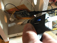 Applying hot glue to the back of the sensor board