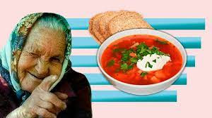 An older woman in a head scarf winks, smiles, and points toward the reader's right shoulder. A bowl of borscht and slices of bread float beside her. A light pink background with horizontal blue bars creates a stylized background.