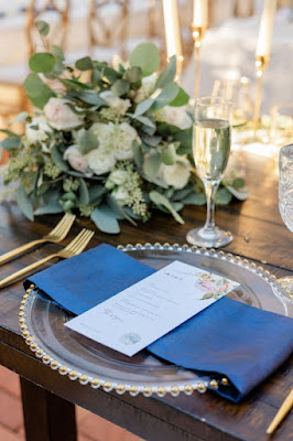 blue linen napkin wrapped around gold beaded charger