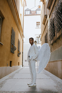 black man dressed in angel wings