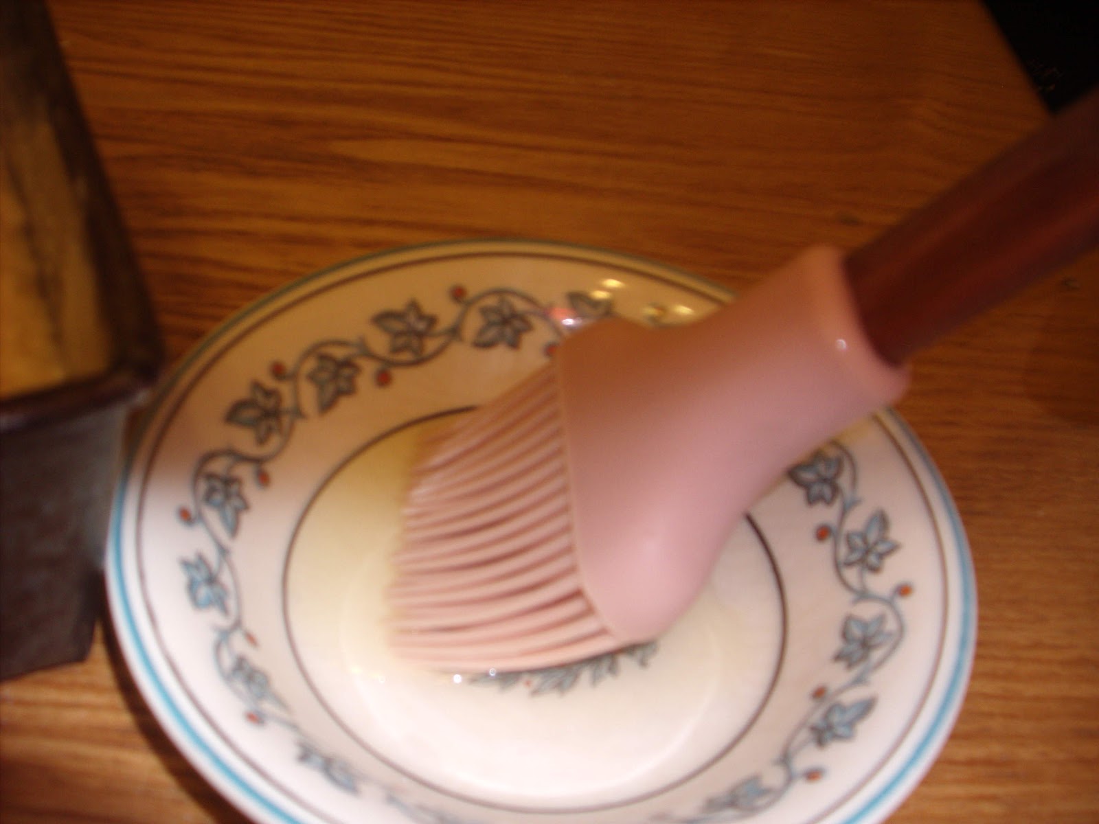 Pour a few tablespoons of oil into a bowl. Use a brush to brush on the ...