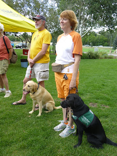 Two Southwest Brighteyes puppy raisers pose with their guide puppies.