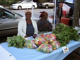 Two immigrant women from Liberia sell their produce in one of West Elmwood's small farmers' markets.