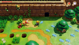 Link in the Blue Mail standing in front of the Fairy Grotto in the Ukuku Prairie. A Pincer is trying to attack him from a hole to the left.