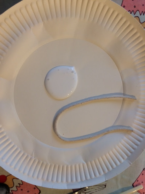 PVA glue on a paper plate along with a piece of string