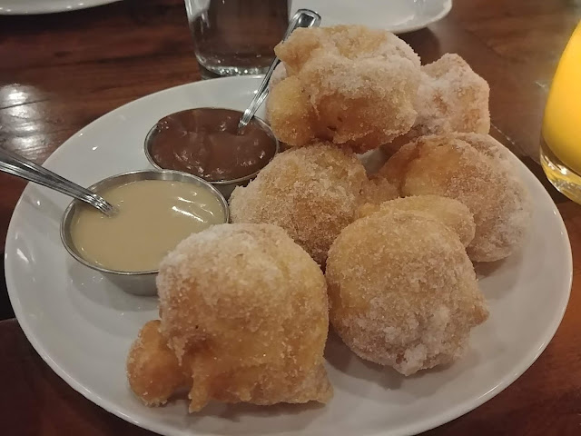 Flufy Beignets - french style doughnuts with creme anglaise and caramel sauce at the Marc Restaurant - in Edmonton