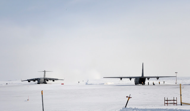 "A Hercules C-130J is being off loaded as a C-177 Globemaster III lands at Canadian Forces Station (CFS) Alert. Both aircraft carry supplies for the station in support of Operation BOXTOP" Photo: MCpl Shilo Adamson (April 25, 2012) IS2012-4006-7