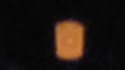 Orange rectangle UFO with symbols.