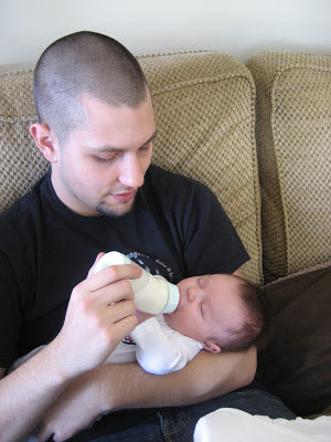 father feeding baby boy