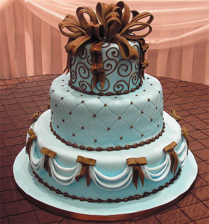 Three tier blue wedding cake with brown bows