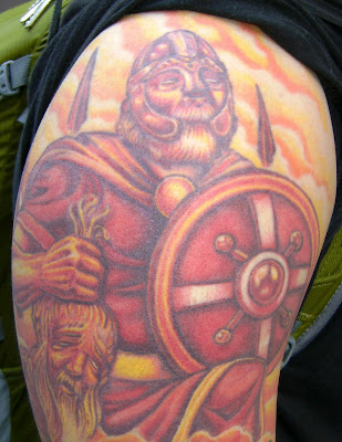  as represented by the Viking warrior at the top of the shoulder