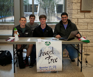 Jeffery and Ricardo working at Angel Tree Table with two other ALOT members