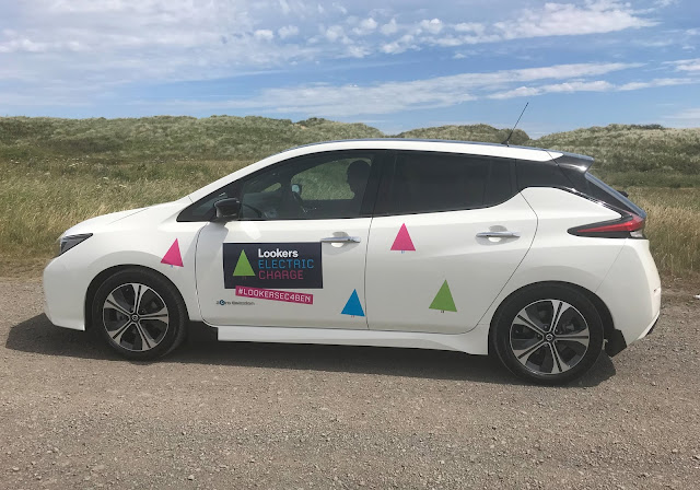 White Nissan Leaf car at the coast