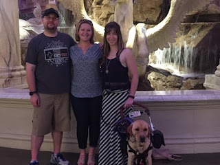 Photograph of Tim, Kaitlyn, Zido and I standing in front of an indoor fountain