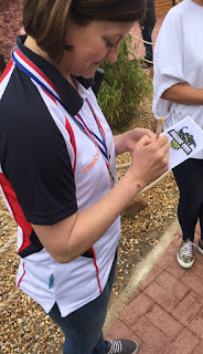 Emily signing an autograph at the minigolf event