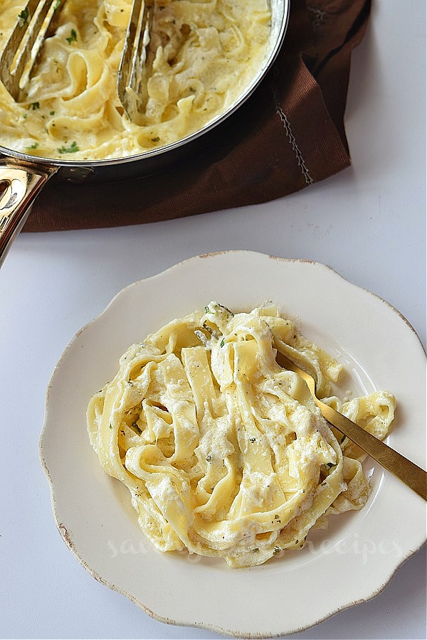 a top view of white plate with fettuccine pasta