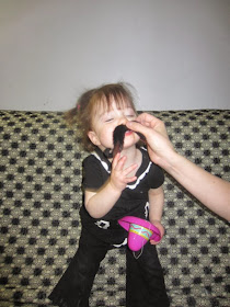 toddler girl with fake mustache and hat