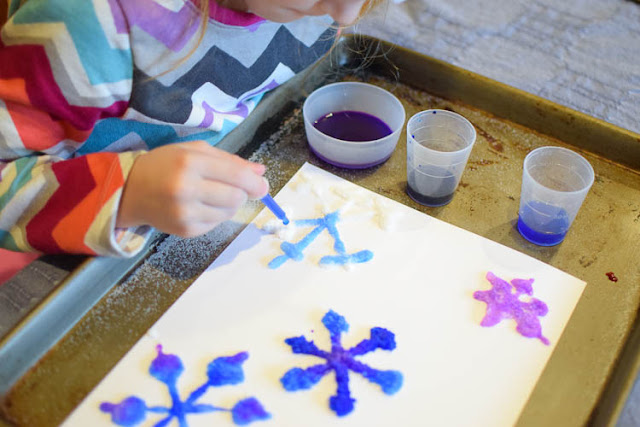 Salt Painted Snowflakes- fun winter process art activity for preschool, kindergarten, or elementary kids. Great for fine motor development, color theory, and science!