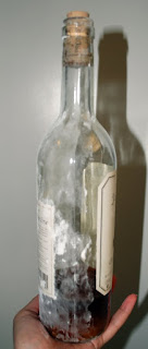 Wrapping half a bottle of wine in fondant as a mold to shape a sugar bottle