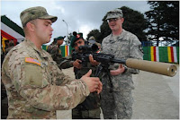 US army personnel showing their berreta sniper to Indian soldier