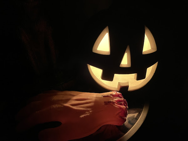 Pumpkin next to severed hand