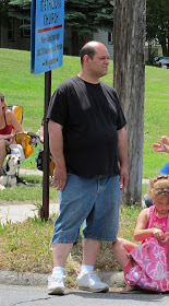 still frowning at parade, unhappy, jean shorts