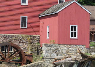 Not everyone zooms in on the little red outbuilding next to the water wheel.