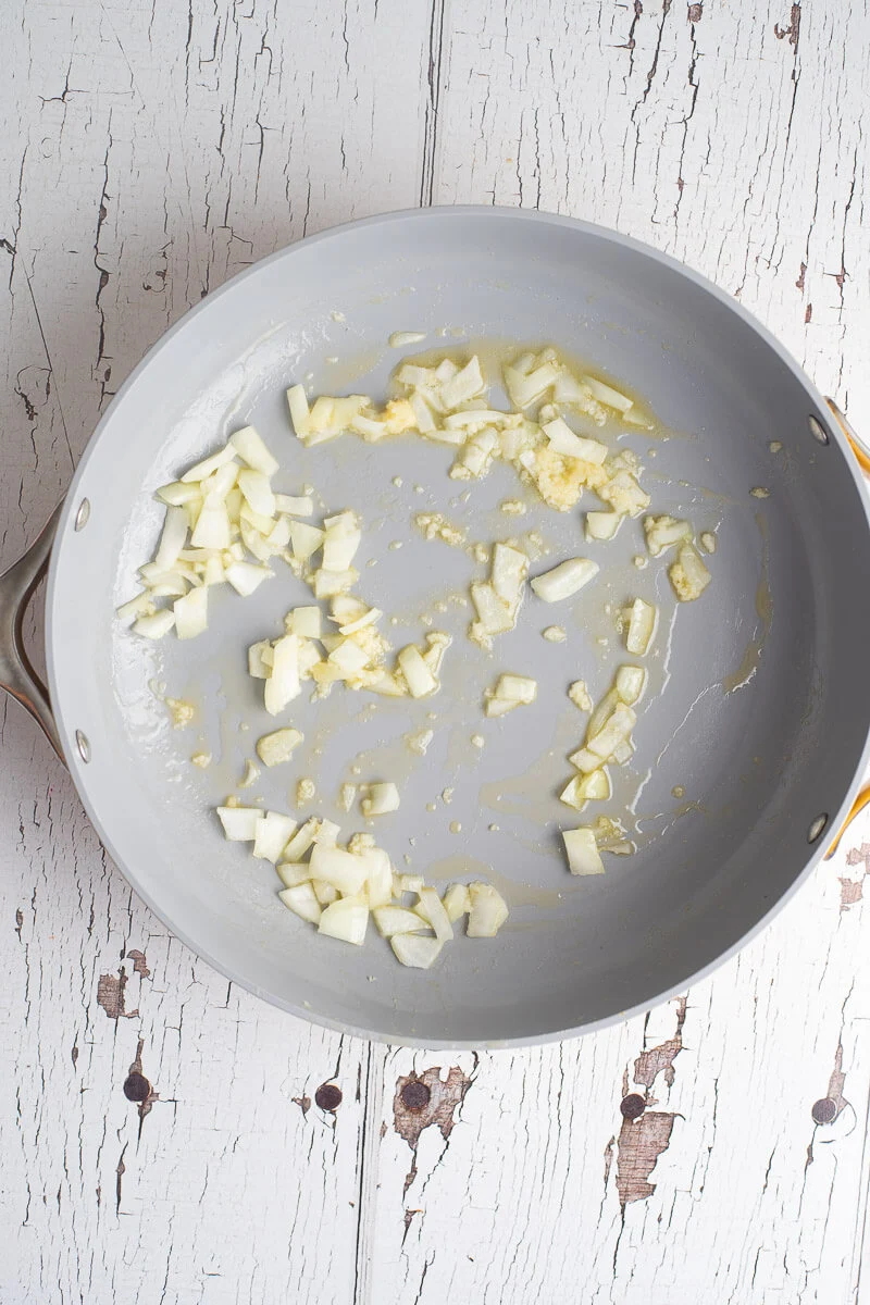 Onions in a skillet with melted butter.