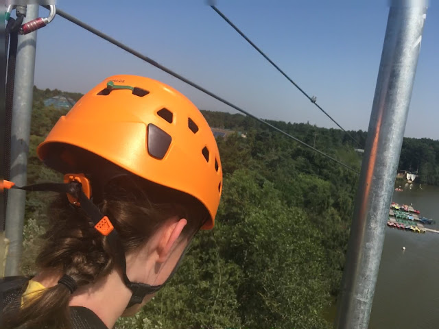 Teen about to do the super long zipline across the lake at center parcs