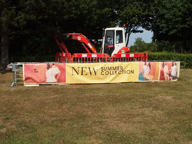 An amusing juxtaposition of an advert and digger in Chippenham