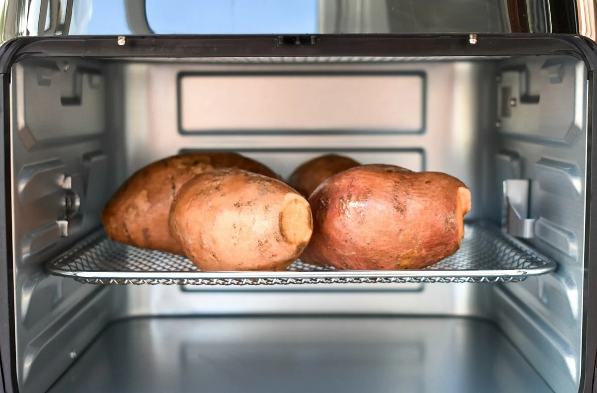 uncooked sweet potatoes in an air fryer