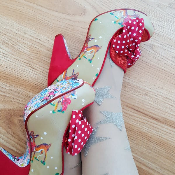 wearing deer print shoes with red glitter and polka dot bow