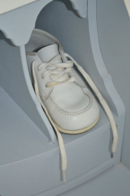 The baby shoes are displayed and are sweet to remember tiny little 