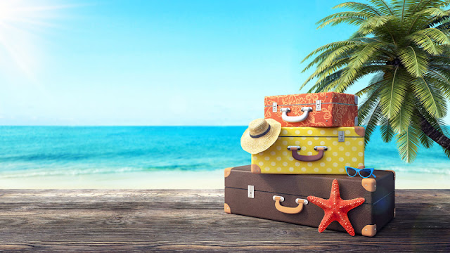 a stack of suitcases in front of the beach