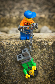One lego guy helping another